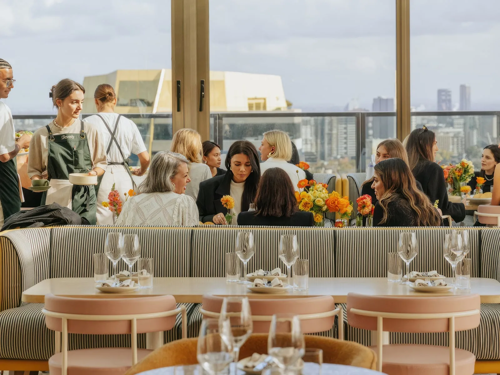 Bone white concrete restaurant tables in the indoor dining room at The Beverly Rooftop, Chapel Street South Yarra