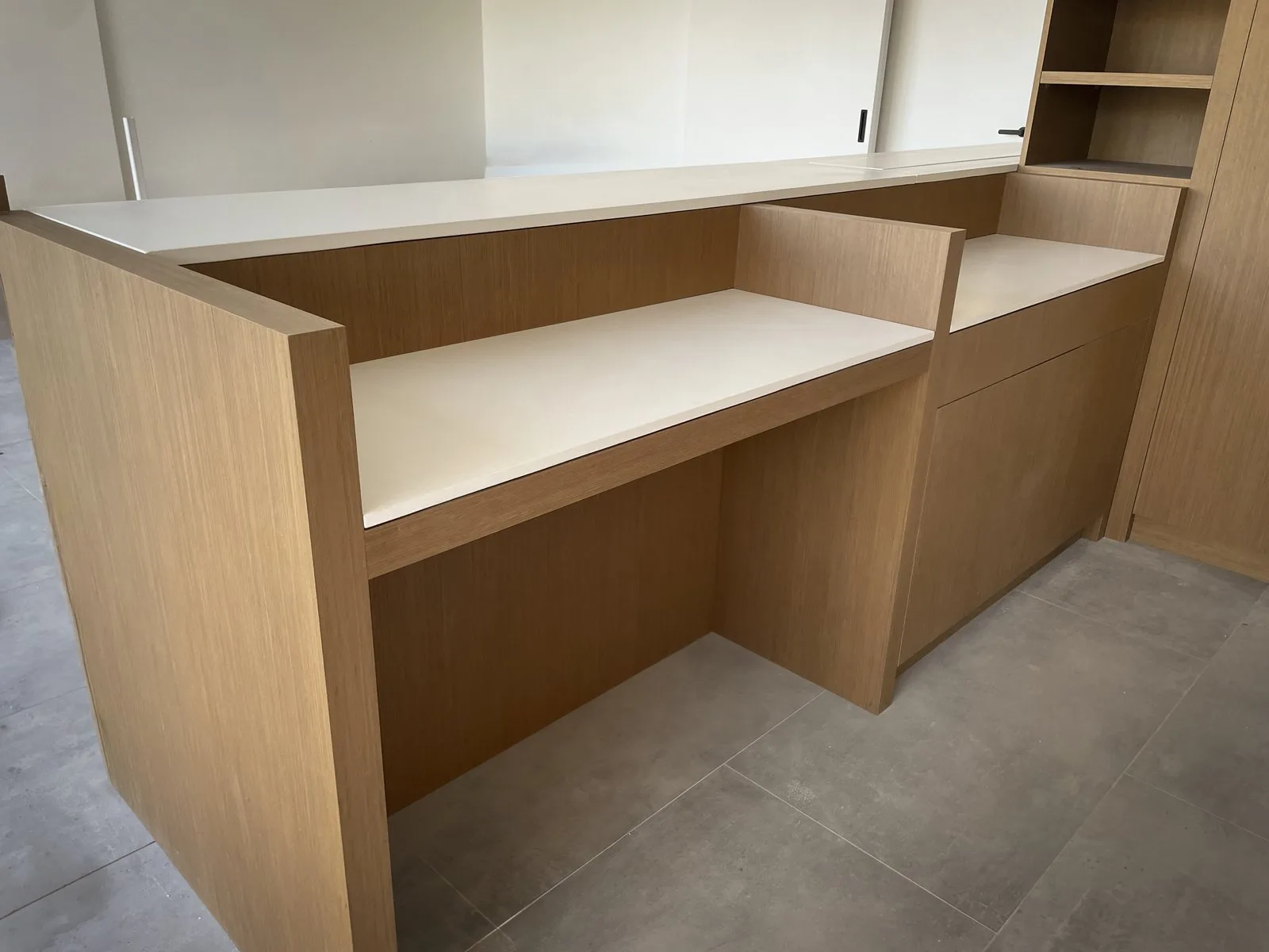 Concrete laundry benchtop in bone white pigment in the Elsternwick SG2 Architects project, set into oak cabinetry, dry-zone application