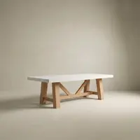 Farmhouse concrete dining table in bone white with the natural-oak A-frame trestle base, studio render on a soft neutral backdrop