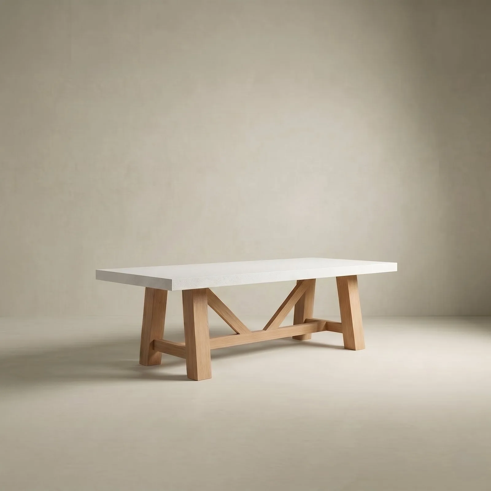 Farmhouse concrete dining table in bone white with the natural-oak A-frame trestle base, studio render on a soft neutral backdrop
