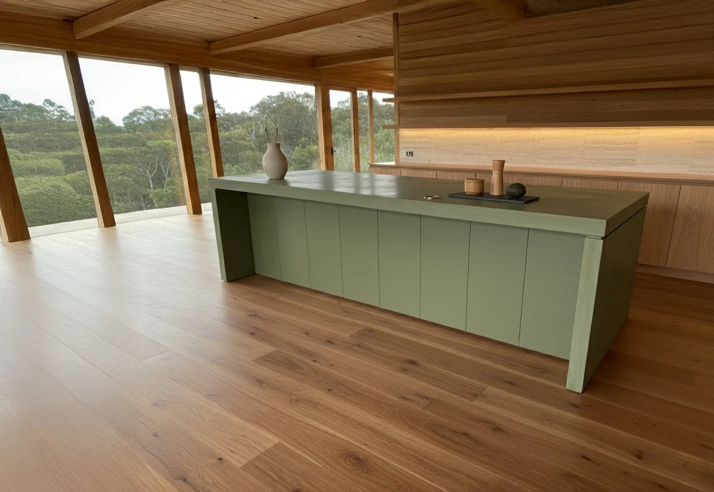 SnapCo concrete kitchen island in a lichen green pigment with timber-clad base in a sunlit interior