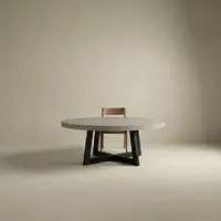 Studio render of the round IronCross concrete dining table on its black steel cross-base, paired with a single timber chair