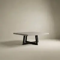 Studio render of the square IronCross concrete dining table on its black steel cross-base on a cream backdrop