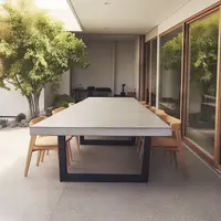 IronStone concrete dining table on a sunlit courtyard patio with timber chairs