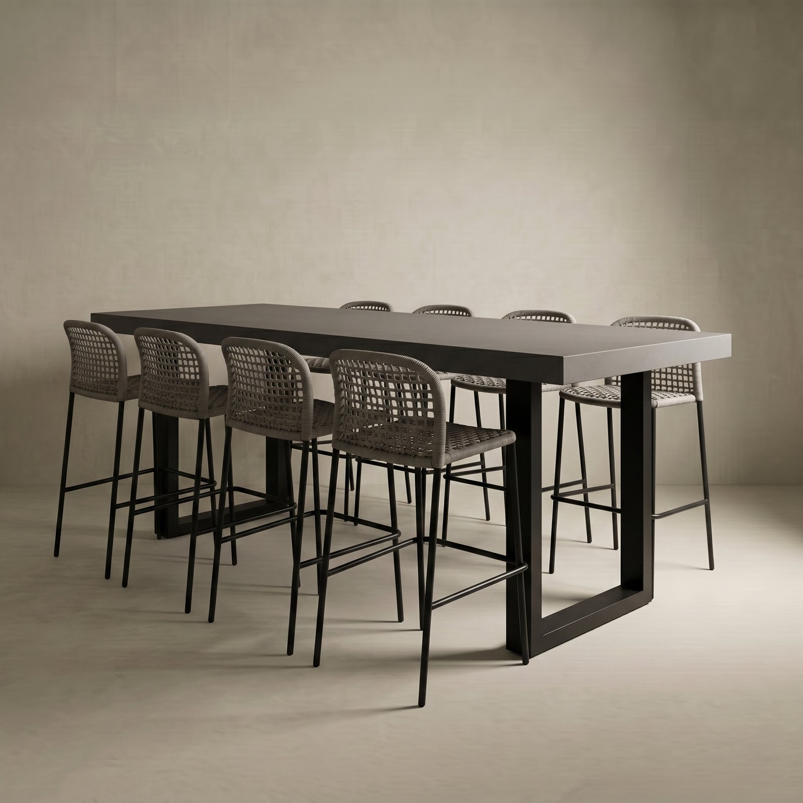 Studio render of the IronStone concrete bar table in dark grey with black steel sled legs and woven barstools