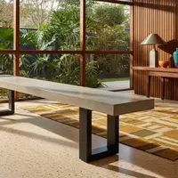 IronStone concrete bench seat in a mid-century interior with timber slat wall, terrazzo floor and garden view