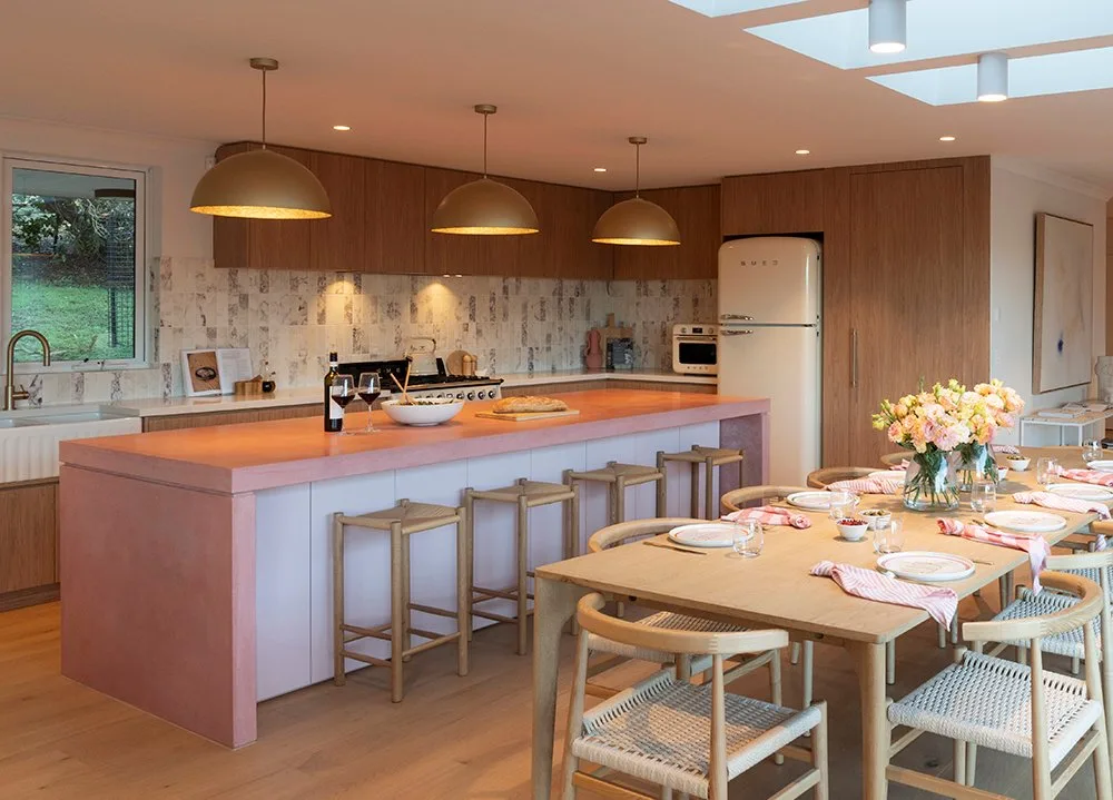 Pink concrete kitchen island with waterfall edges in the Research Victoria home