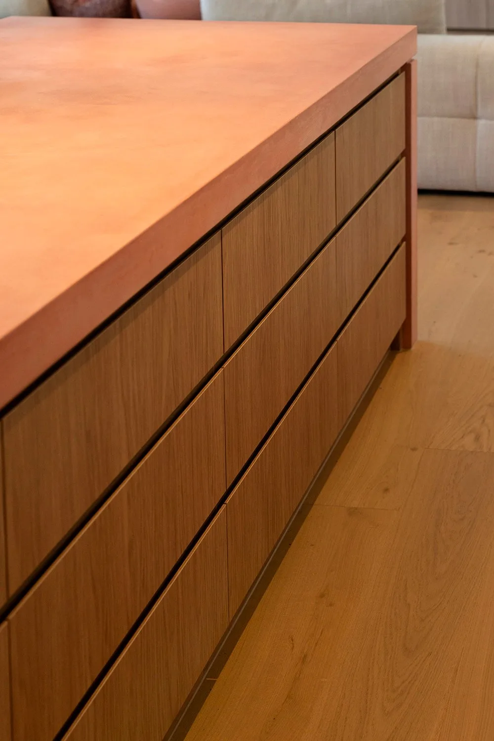 Side view of the pink concrete kitchen island and oak drawer joinery on Love It or List It Australia