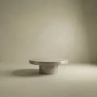 Milano round concrete coffee table studio shot on a cream backdrop