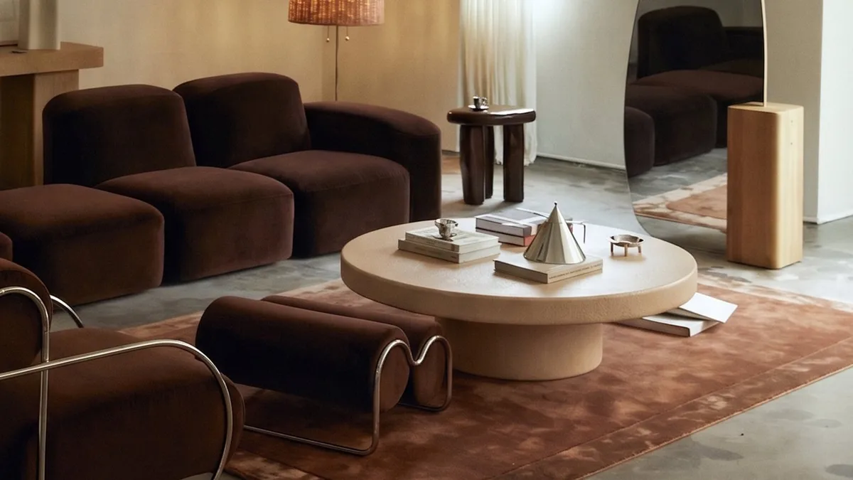Milano round concrete coffee table by SnapCo on a living-room rug, hand-cast in Mordialloc