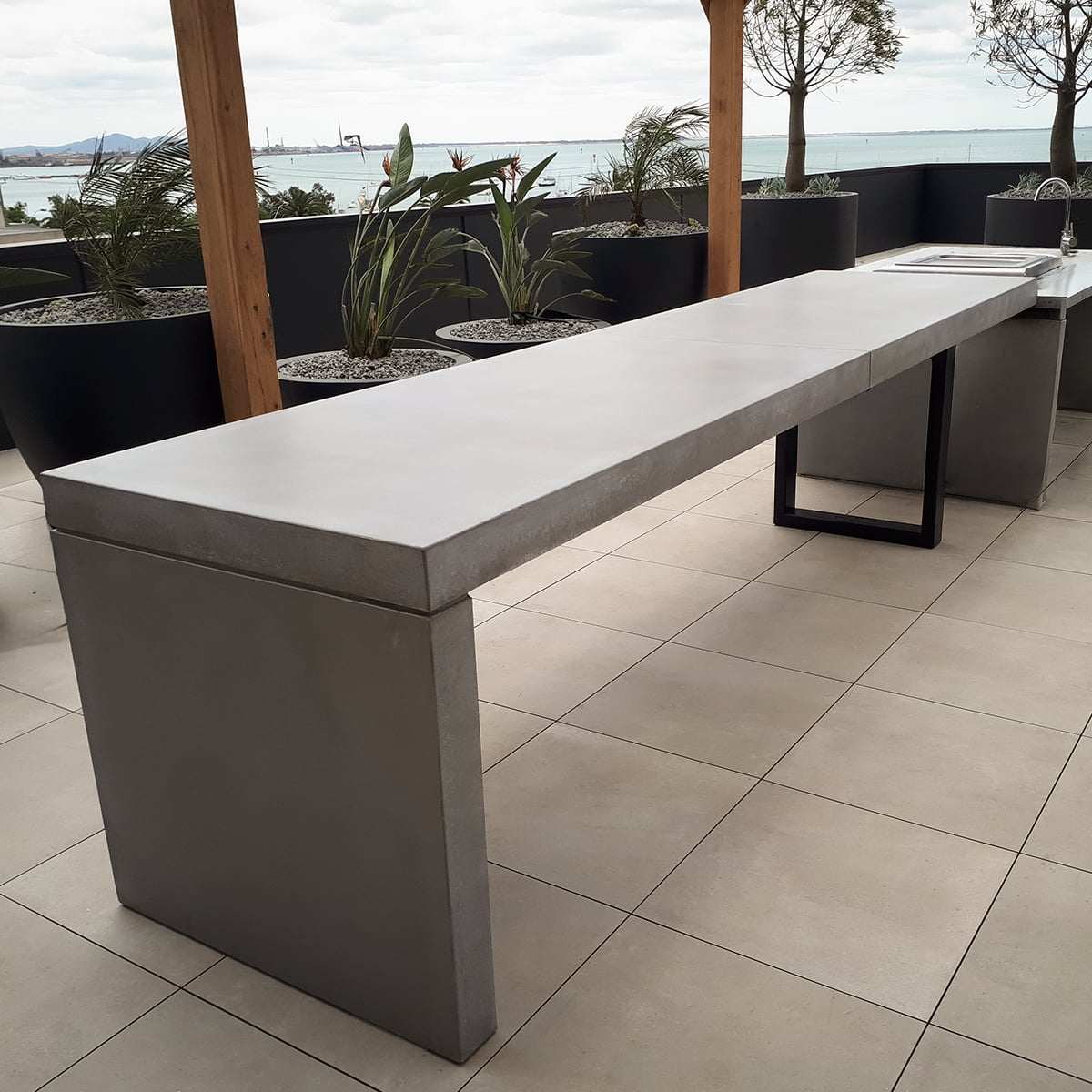 Concrete outdoor kitchen benchtop by SnapCo with cast-in BBQ cut-out, splashback and pigment finish