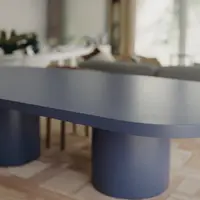 Navy Palermo oval concrete dining table close-up showing the cast edge and twin pedestal base