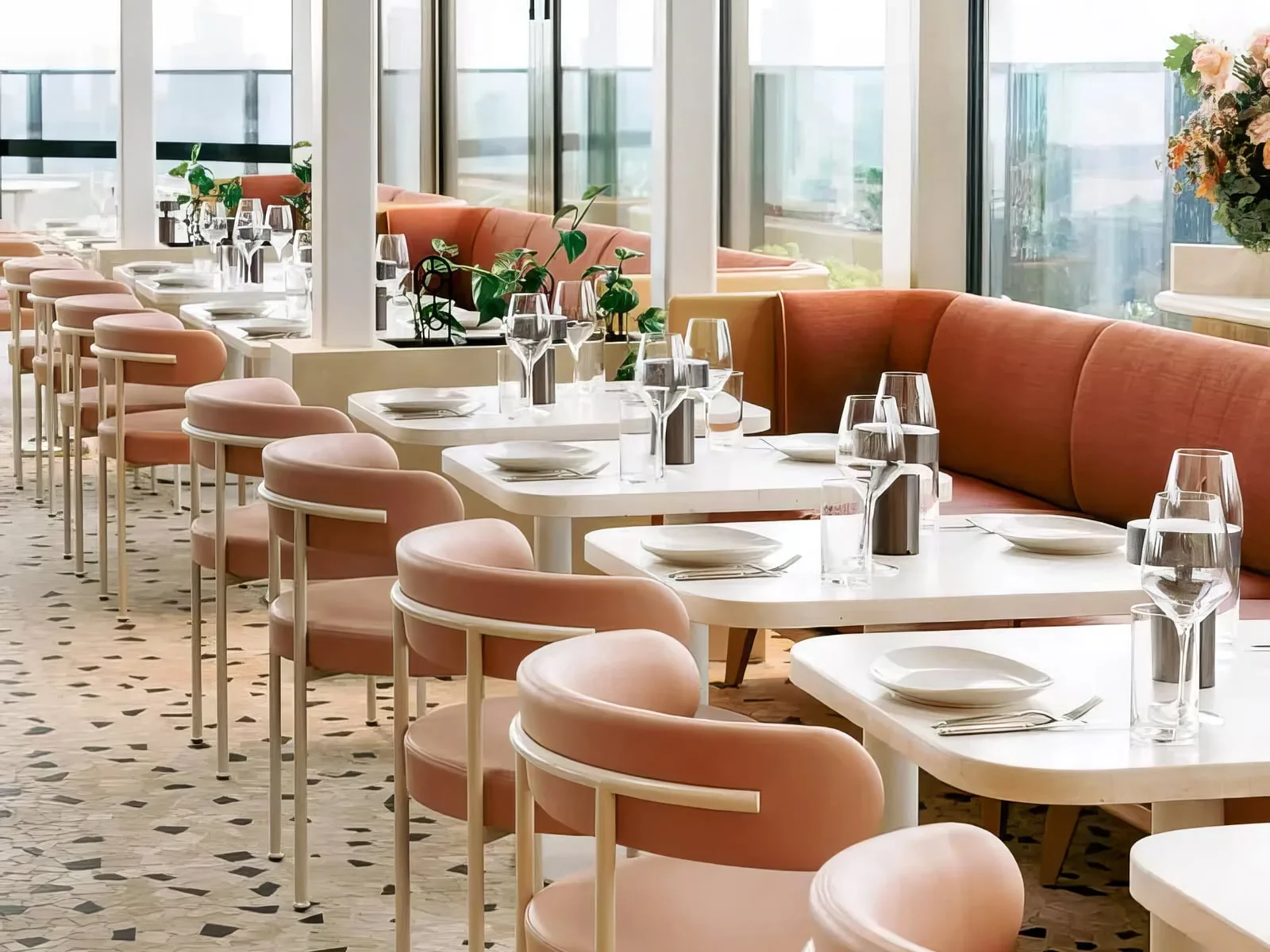 Concrete cafe tables and pink banquette seating at The Beverly Rooftop in South Yarra, a SnapCo commercial commission