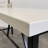 SnapCo Santino concrete bar table with bone-white top and steel base, photographed in situ