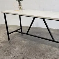 SnapCo Santino concrete bar table with bone-white top and steel base, in situ side angle