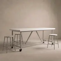Santino concrete bar table in bone white with light steel legs, lockable caster wheels and matching round bar stools, studio render on a soft neutral backdrop