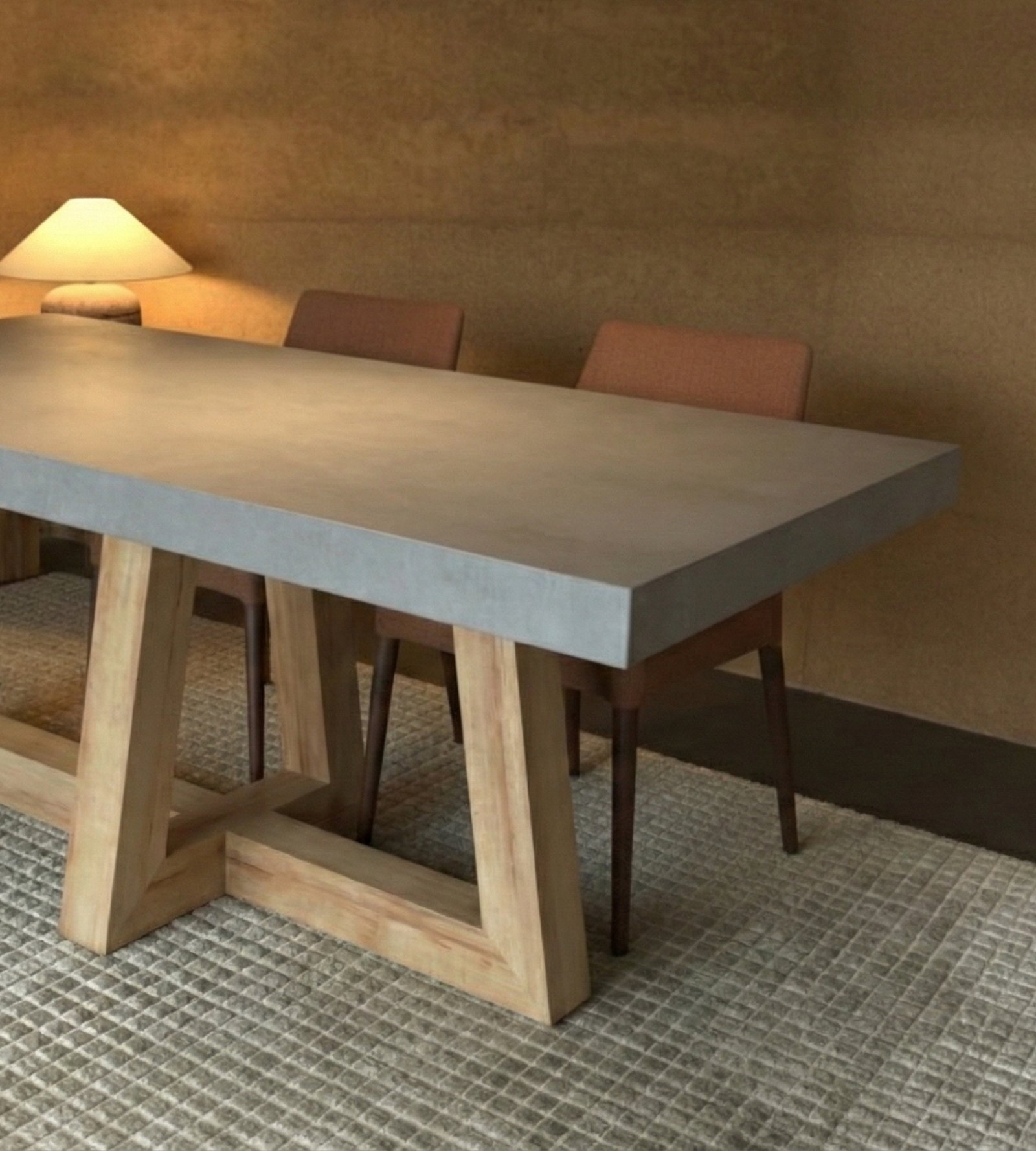 TimberCross concrete dining table in a warm dim-lit room with terracotta dining chairs and lamp