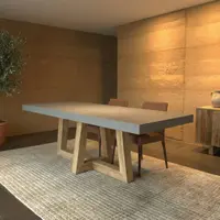 TimberCross concrete dining table in a Balmain dining room with rammed-earth walls and olive tree