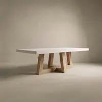 TimberCross concrete dining table in bone white with the natural-oak crossing trestle base, studio render on a soft neutral backdrop