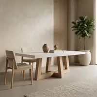 TimberCross concrete dining table in a minimalist plaster-walled room with oak chairs, fluted timber panelling and fiddle-leaf fig
