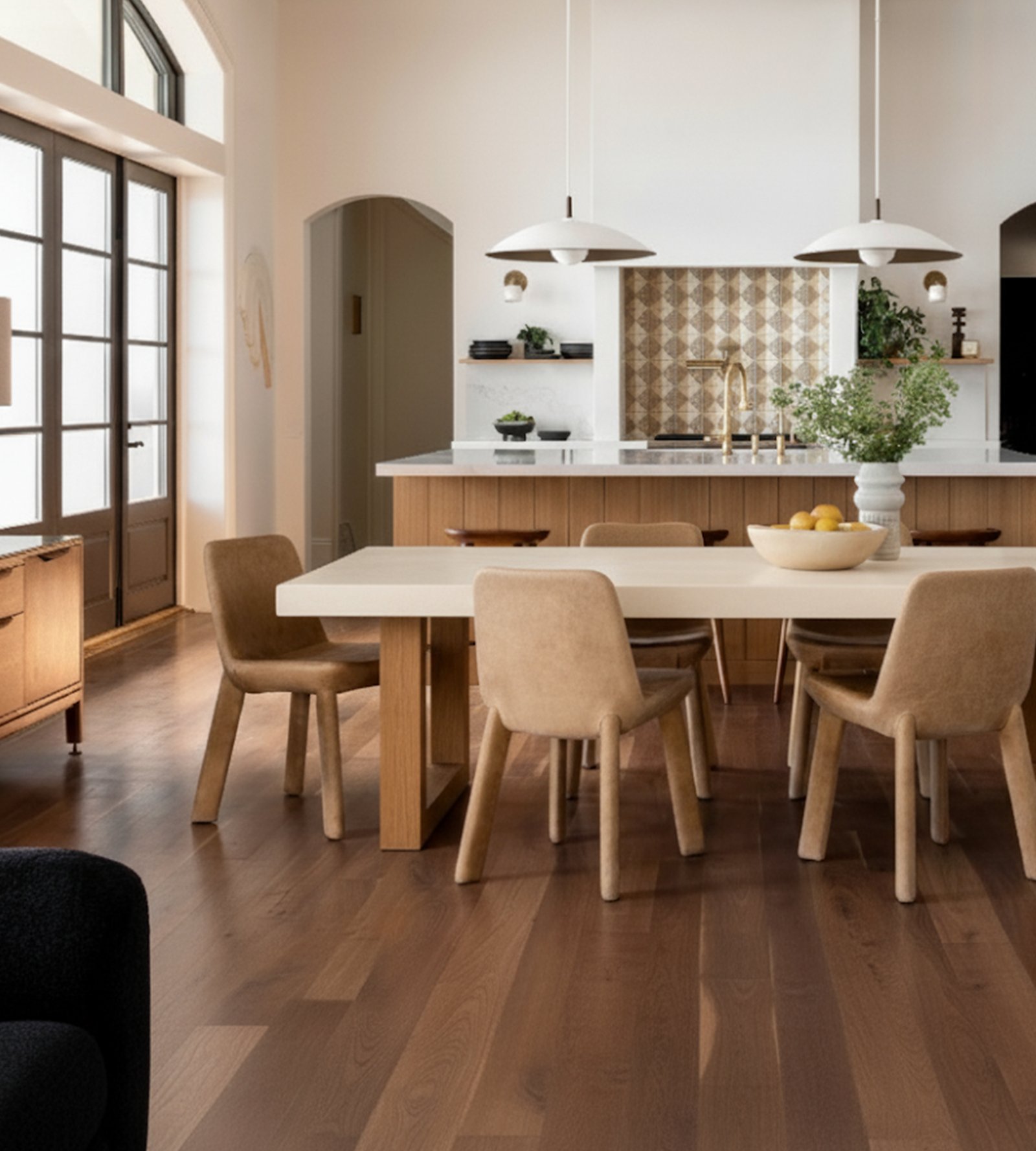TimberStone concrete dining table in a bright Mediterranean kitchen with arched doorways and tan chairs
