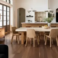 TimberStone concrete dining table in a bright Mediterranean kitchen with arched doorways and tan chairs