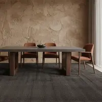 TimberStone concrete dining table with terracotta chairs against a textured plaster wall
