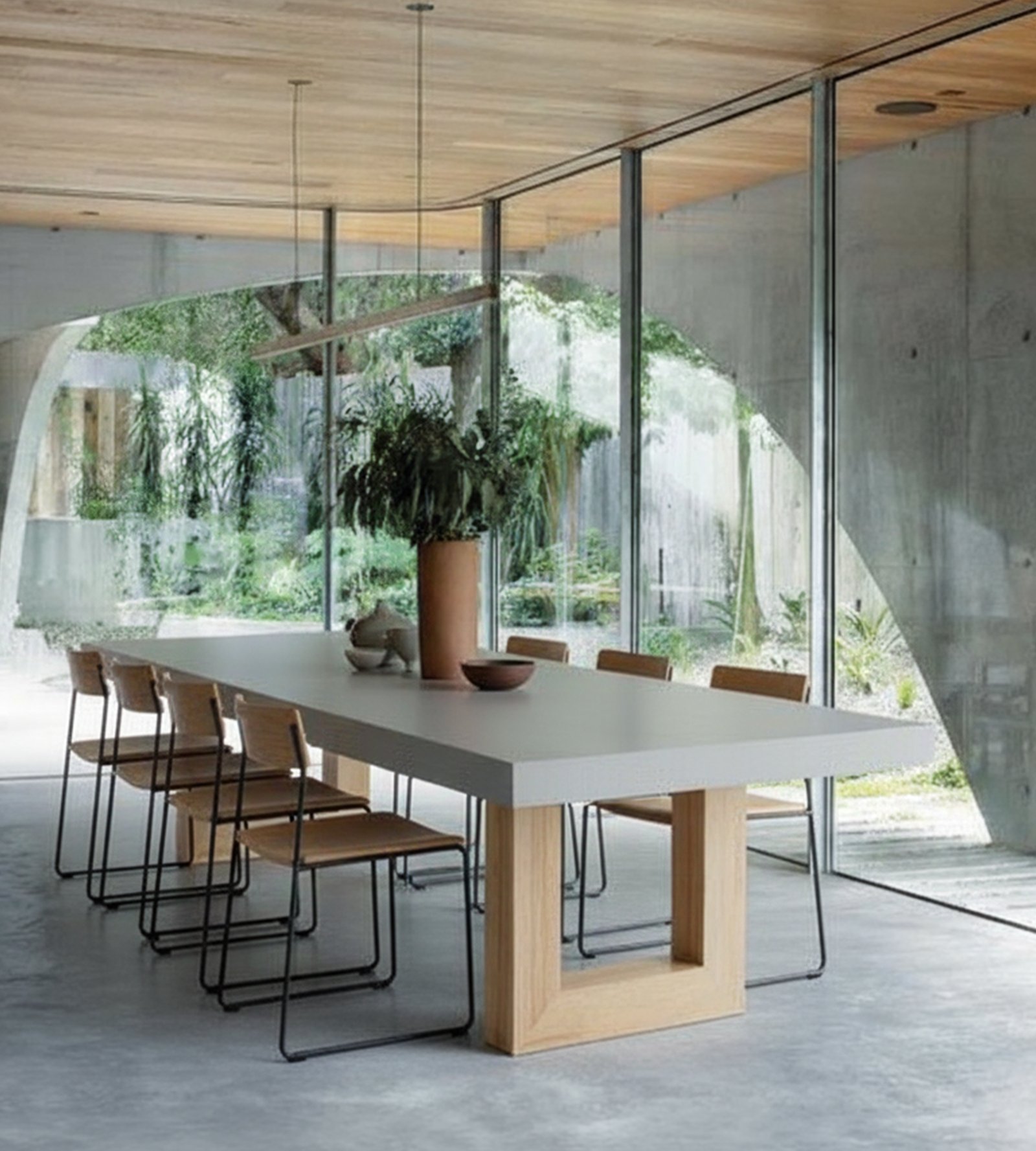 TimberStone concrete dining table in a concrete and timber pavilion with garden view
