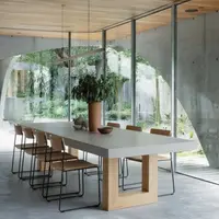 TimberStone concrete dining table in a concrete and timber pavilion with garden view