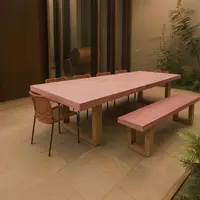 TimberStone concrete dining table and bench in pink pigment, outdoor courtyard with sandstone paving