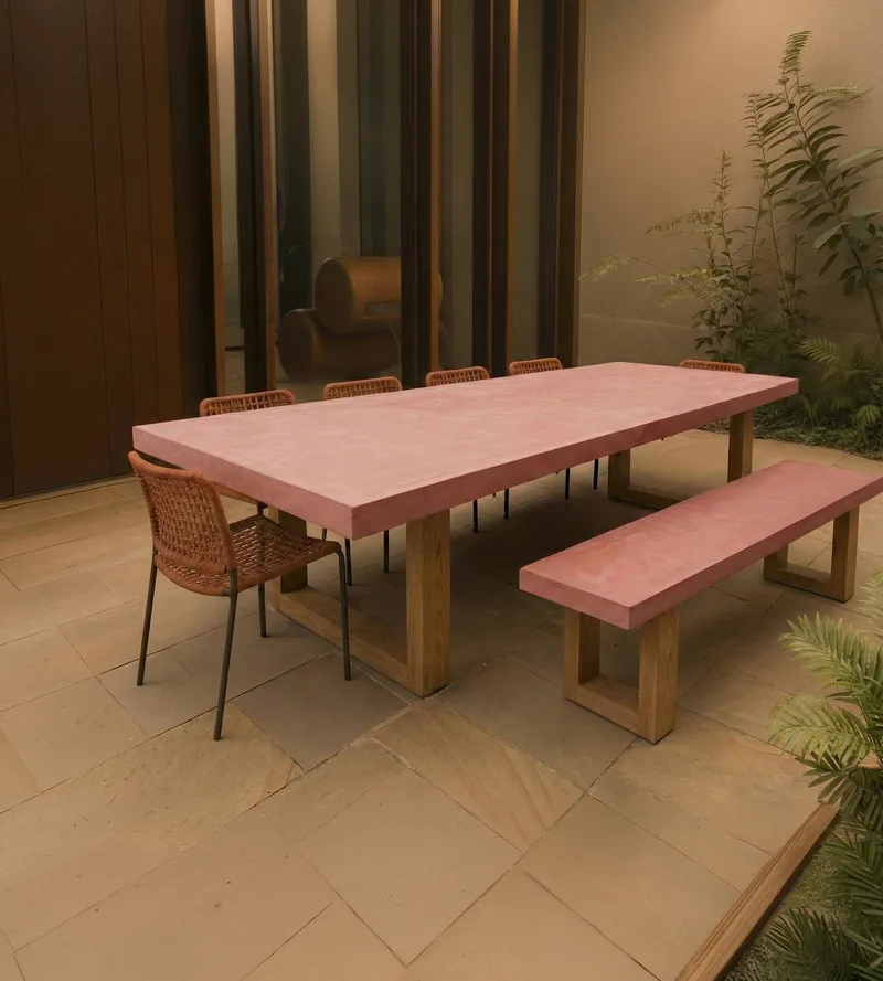 TimberStone concrete dining table and bench in pink pigment, outdoor courtyard with sandstone paving