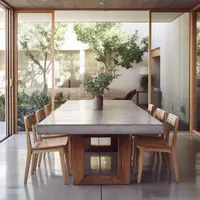 TimberStone concrete dining table in a glass-walled room with timber chairs and garden view