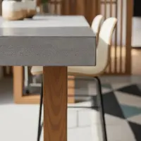 Close-up detail of the TimberStone concrete bar table edge with light timber leg