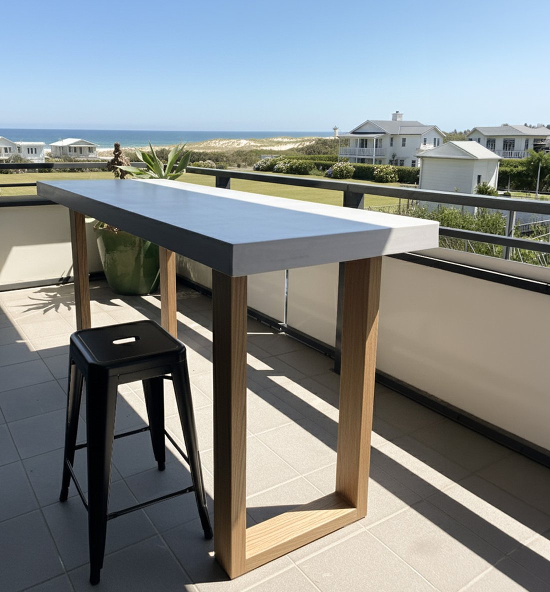 TimberStone concrete bar table on a Gold Coast balcony with ocean and beach view behind