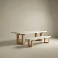 Studio render of the bone-white TimberStone concrete bench seat paired with the matching dining table on natural Tasmanian Oak legs